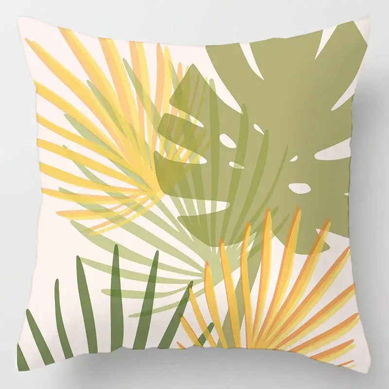 Square cushion cover with vibrant geometric leaves print in yellow green and olive on off-white for living room decor