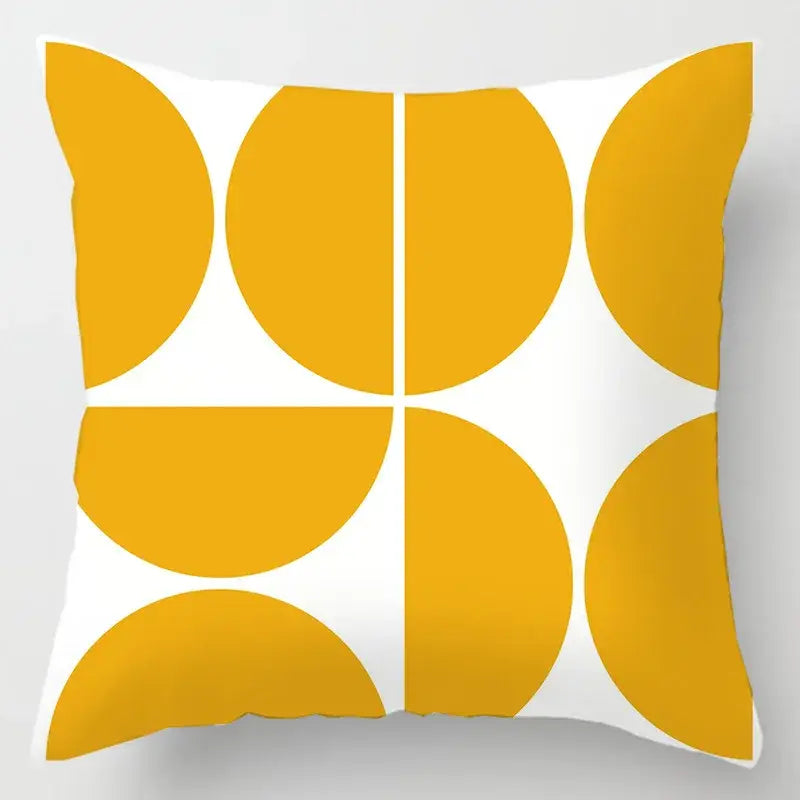 A square cushion cover with bold mustard yellow geometric leaves print on white for living room decor