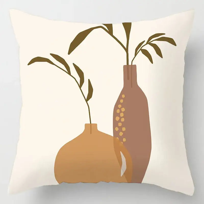 Cream-colored cushion cover with geometric leaves print and minimalist terracotta vases for living room decor