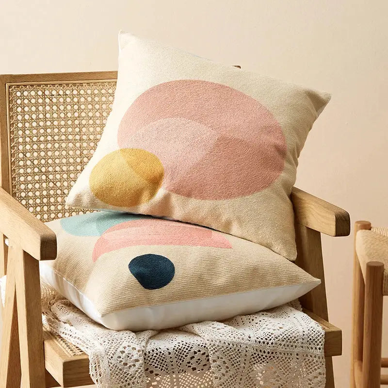 Beige cushion cover with embroidered pastel geometric shapes in pink mustard and navy for living room decorbites geometric cushion
