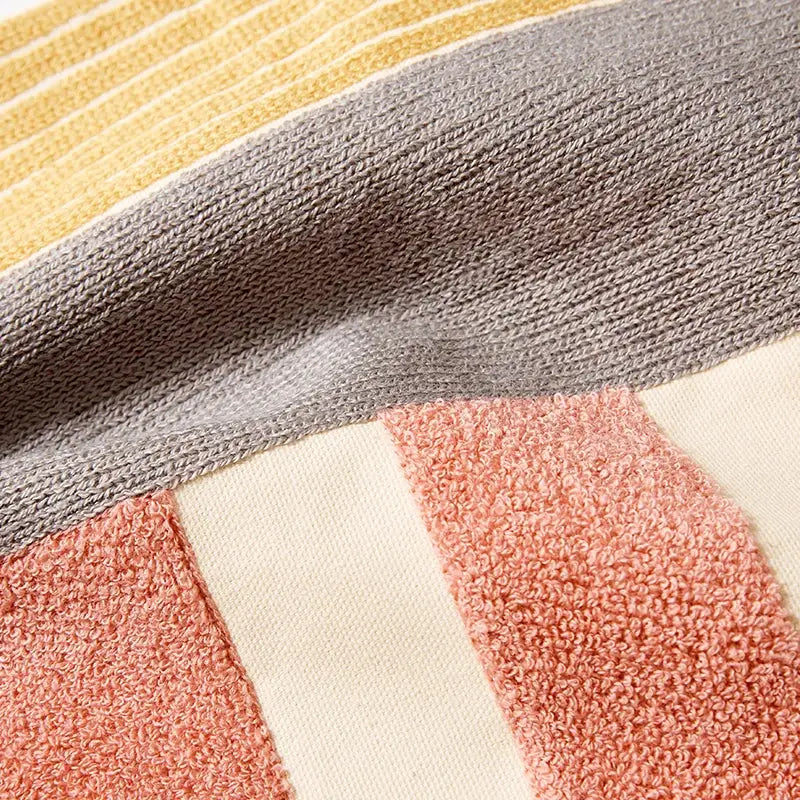 Abstract pastel geometric cushion cover with a soft textured towel fabric in mustard yellow gray cream and dusty rose colors