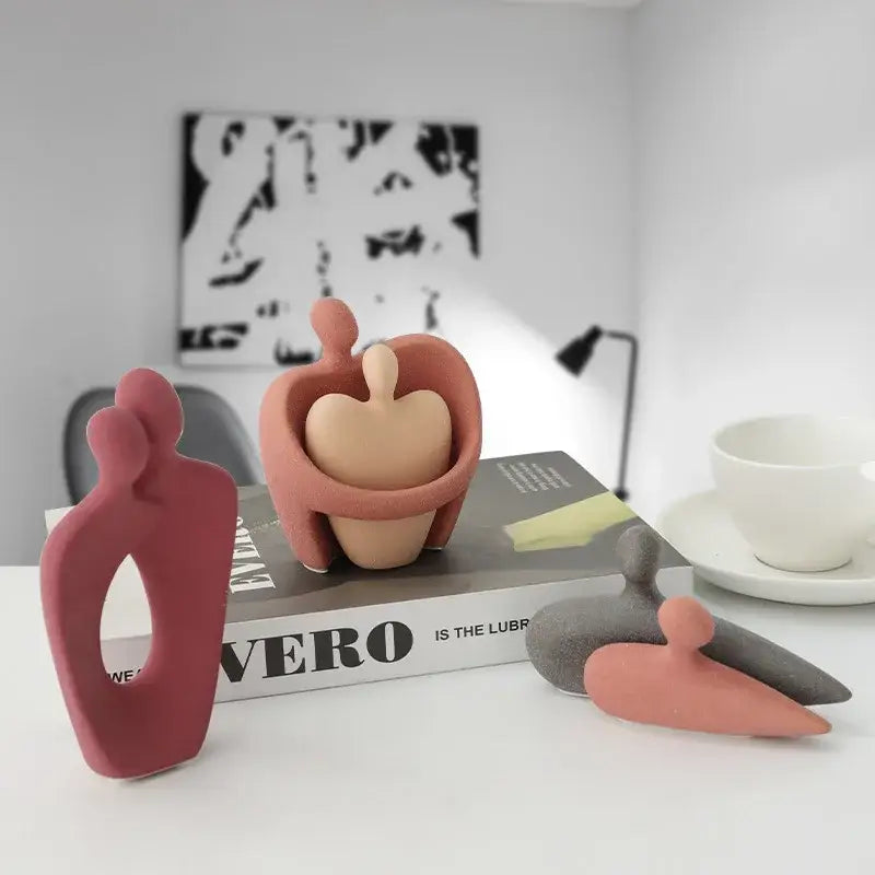 Terracotta-colored abstract pink and beige ceramic art couple statue with smooth matte finish for living room decor