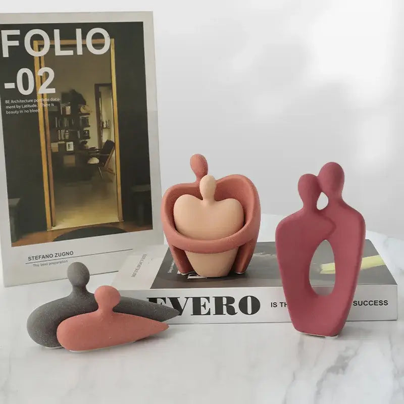 Abstract pink and beige ceramic art couple statue with smooth matte finish for living room decor
