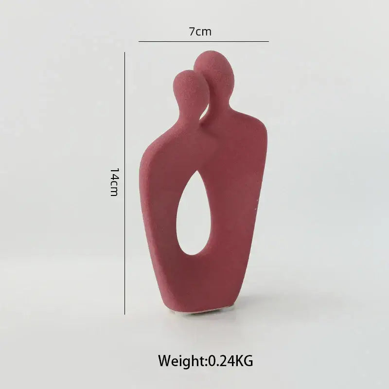 Minimalist red ceramic art couple statue with two abstract figures embracing and an oval cutout for living room decor
