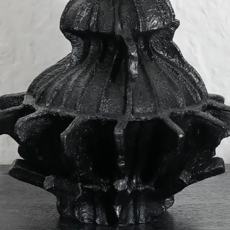 Black textured abstract pleated gear resin vase with intricate ridges for living room decor and flower holding