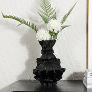 Black ruffled ceramic abstract pleated gear vase with white flowers and green ferns for living room decor