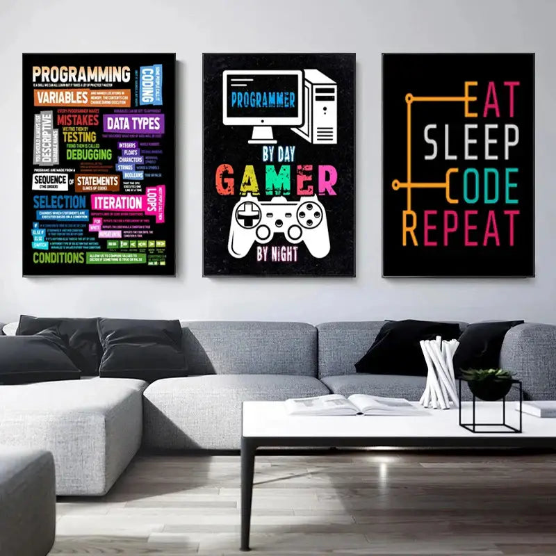Three framed posters with vibrant abstract programmer gamer text and graphics above a gray sectional sofa in canvas art