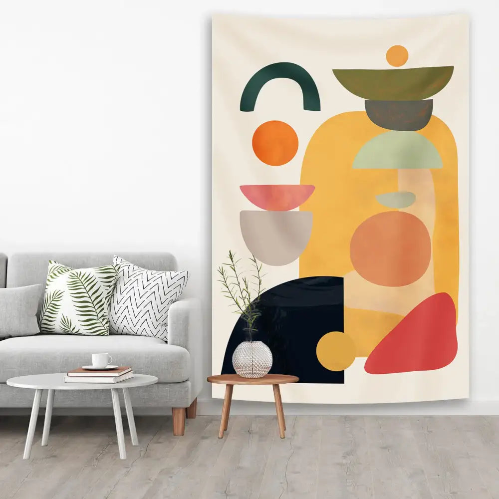 Abstract geometric tapestry yoga mat with layered mustard yellow orange teal green and red shapes on cream background