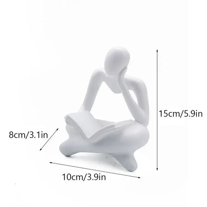 White abstract resin book figurine of a seated thinker holding an open book for decorbites office decorbites abstract resin