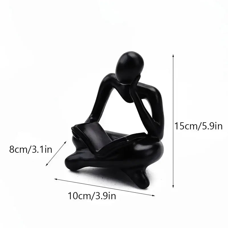 Black glossy resin book figurine of a seated thinker with hands on chin in decorbites abstract resin office decor