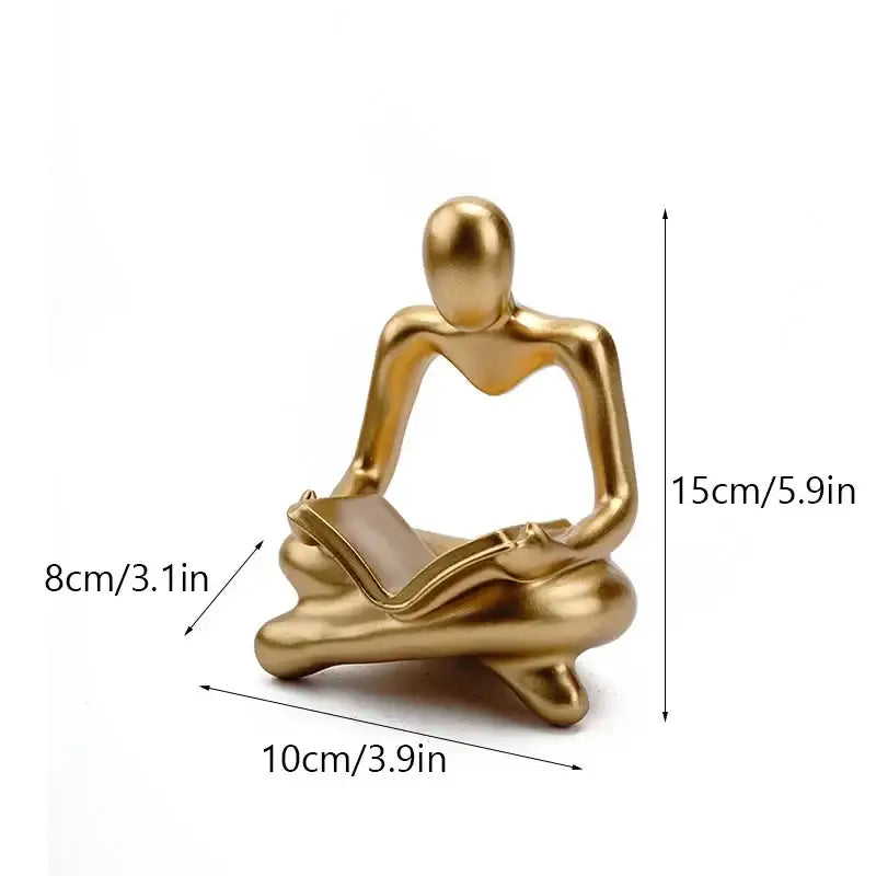 Golden metallic resin book figurine of a seated person reading for decorbites abstract resin black and white office decor