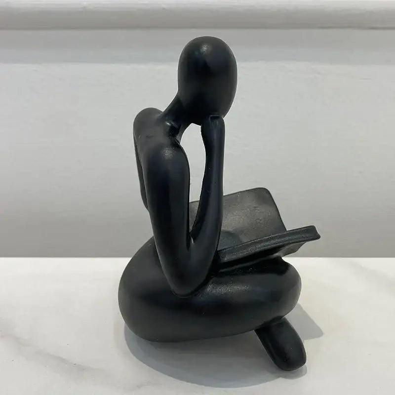 Black matte abstract resin book figurine of a seated thinker for office decor by decorbites abstract resin collection