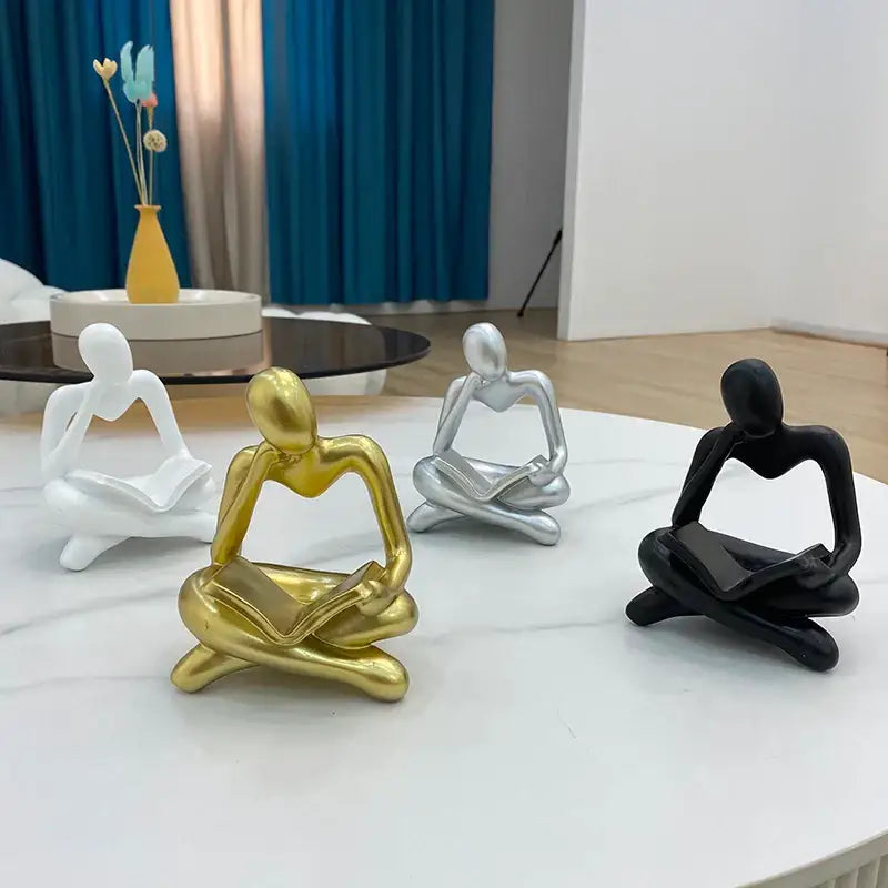 Shiny gold abstract resin book figurine sitting in a meditative pose for decorbites abstract resin office decor