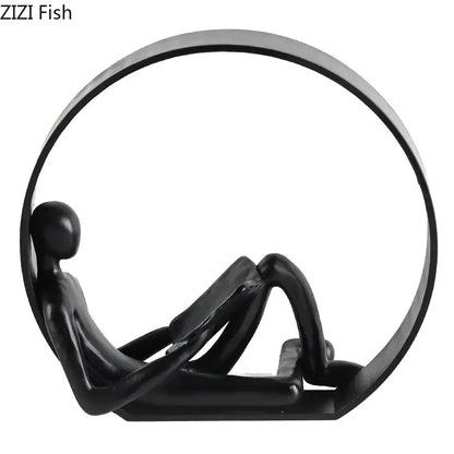Black glossy resin sculpture of a minimalist abstract resin character reclining in a circular frame for home decor