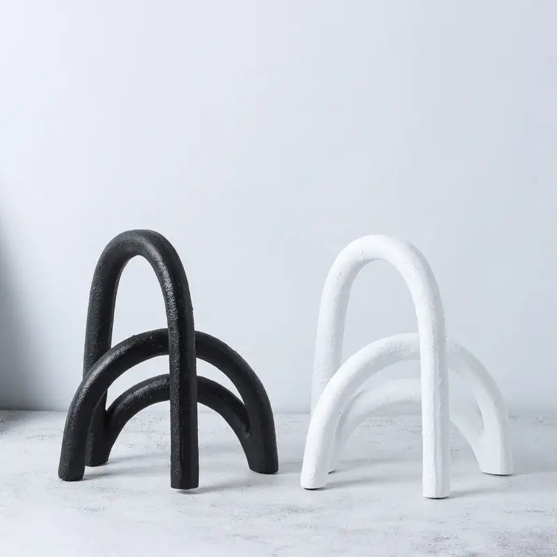 Black and white cast iron arch shaped bookends with textured rustic finish for decorbites abstract resin geometry decor