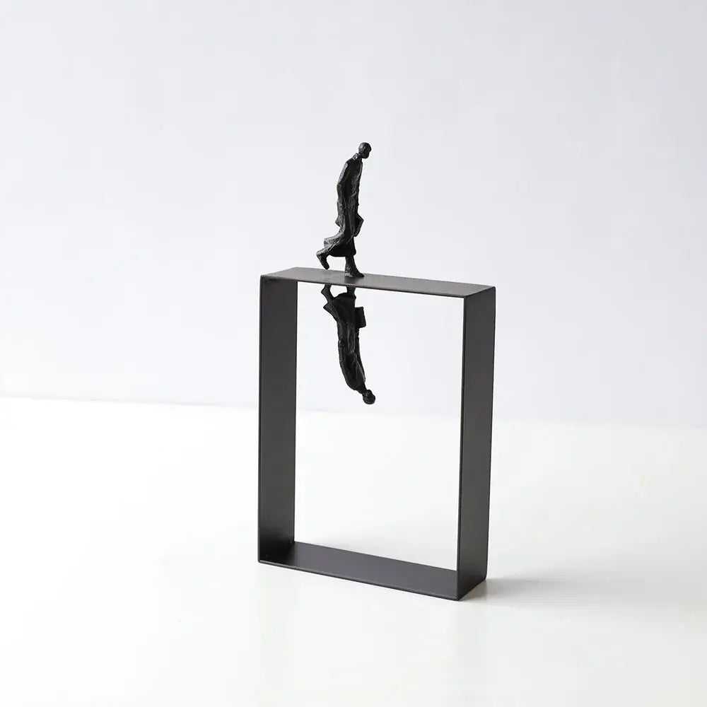 Black metallic abstract resin sculpture of a man walking on a frame with inverted reflection for living room decorbites decor