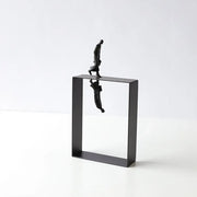 Black metallic abstract resin sculpture of a man walking on a frame with inverted reflection for living room decorbites decor