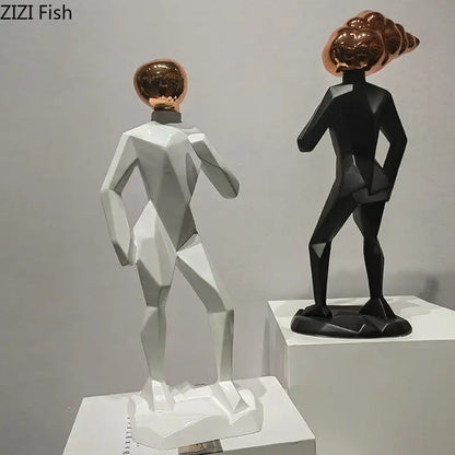 Two stylized abstract resin sculpture figures with white bodies and reflective rose gold heads for room decorbites decor
