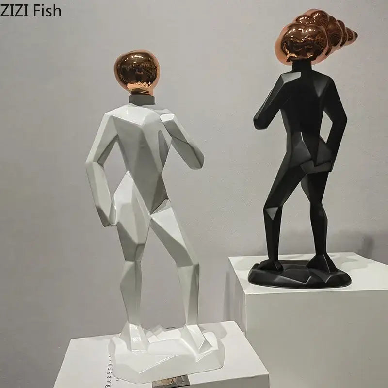 Two stylized abstract resin sculpture figures with white bodies and reflective rose gold heads for room decorbites decor