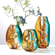 Three hand-blown abstract ripple glass vases with swirling amber and teal patterns for living room decorbites decor