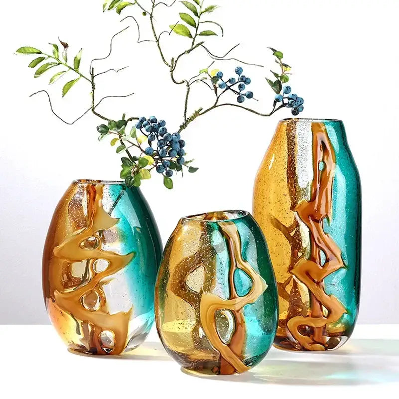 Three hand-blown abstract ripple glass vases with swirling amber and teal patterns for living room decorbites decor
