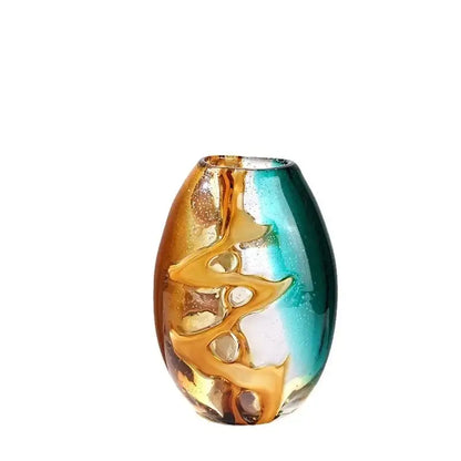 A vibrant hand-blown abstract ripple glass vase with amber teal hues and gold leaf patterns for living room decor