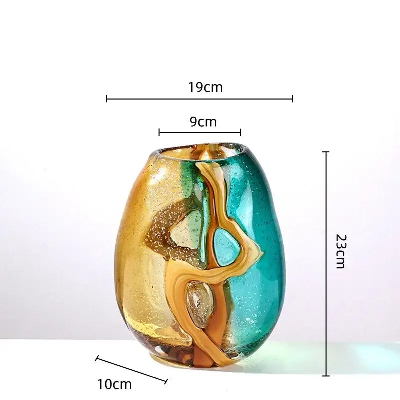 A vibrant hand-blown amber and teal glass vase with abstract ripple design and golden speckles for living room decor