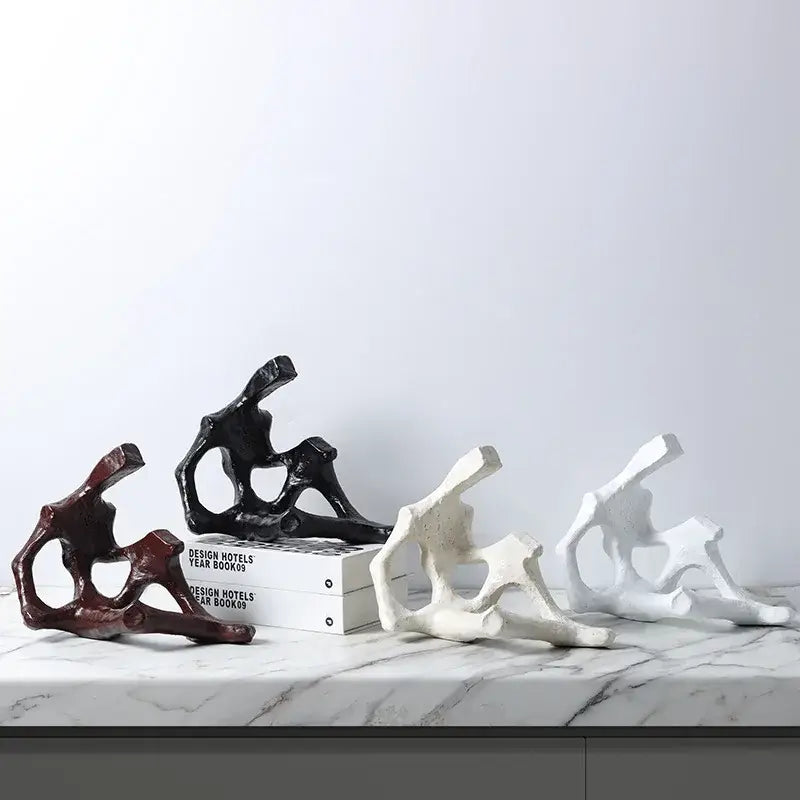 Abstract skeleton decor figure living room bookends in matte black burgundy and off-white resin with bone-like forms by decorbites
