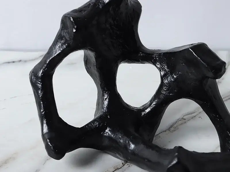 Black glossy resin abstract skeleton decor figure sculpture with bone-like shape and irregular cutouts for living room bookends