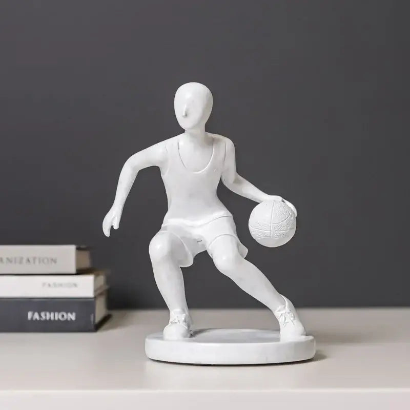 White resin sports player sculpture in dynamic dribbling pose on circular base for decorbites abstract sports decor