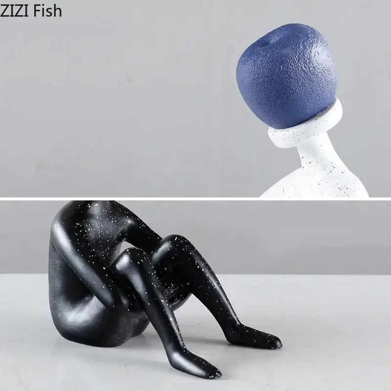 Black glossy resin abstract thinker figurine with white speckles and blue textured spherical head for living room decor