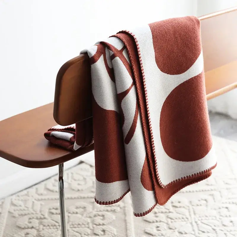 A terracotta and cream throw blanket with a modern abstract pattern in decorbites jacquard imitation cashmere