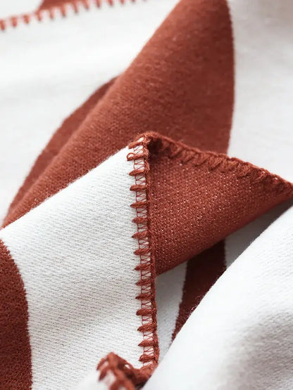 A cozy terracotta and white striped jacquard imitation cashmere throw blanket with zigzag stitched edge decorbites jacquard imitation
