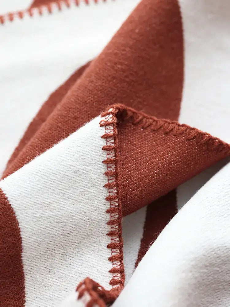 A cozy terracotta and white striped jacquard imitation cashmere throw blanket with zigzag stitched edge decorbites jacquard imitation