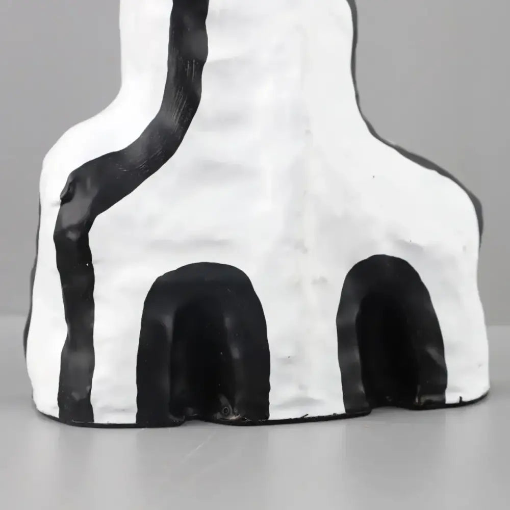 Abstract white ceramic figurine vase with black geometric eye pattern stripes and two arched openings for living room decor