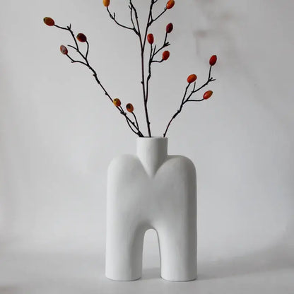 Abstract white geometric ceramic vase shaped like a stylized human torso with arched base for living room decorbites decor