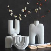 Abstract white geometric ceramic vase with smooth surfaces and human-like forms for living room decor by decorbites