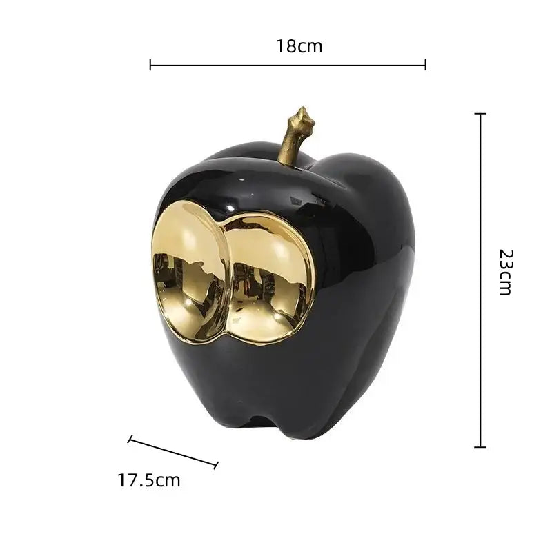 Black glossy ceramic apple sculpture with gold metallic eyes and stem for elegant living room decor golden apple sculpture