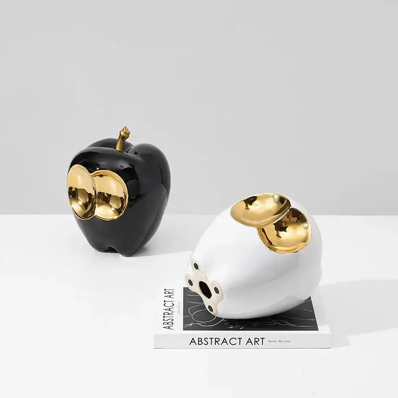 Abstract white and gold ceramic apple sculpture with black accents featuring golden apple design for living room decor