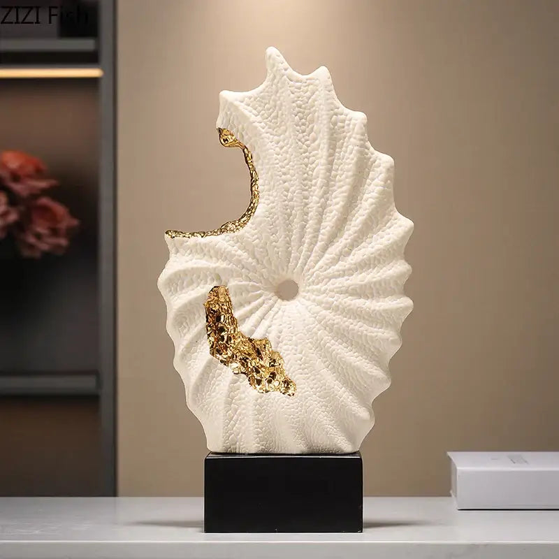 Abstract white and gold gilded ceramic landscape featuring a seashell sculpture on a black base for living room decor