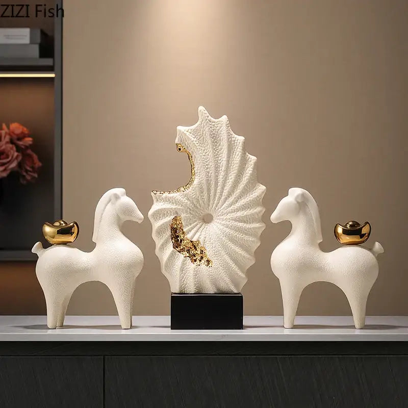 Abstract white and gold gilded ceramic landscape featuring two stylized horses with gold coin accents and spiral shell sculpture