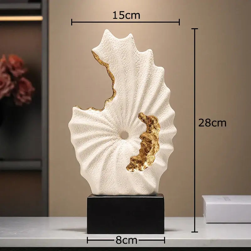 Abstract white and gold gilded ceramic landscape leaf sculpture with textured surface on black rectangular base for decor