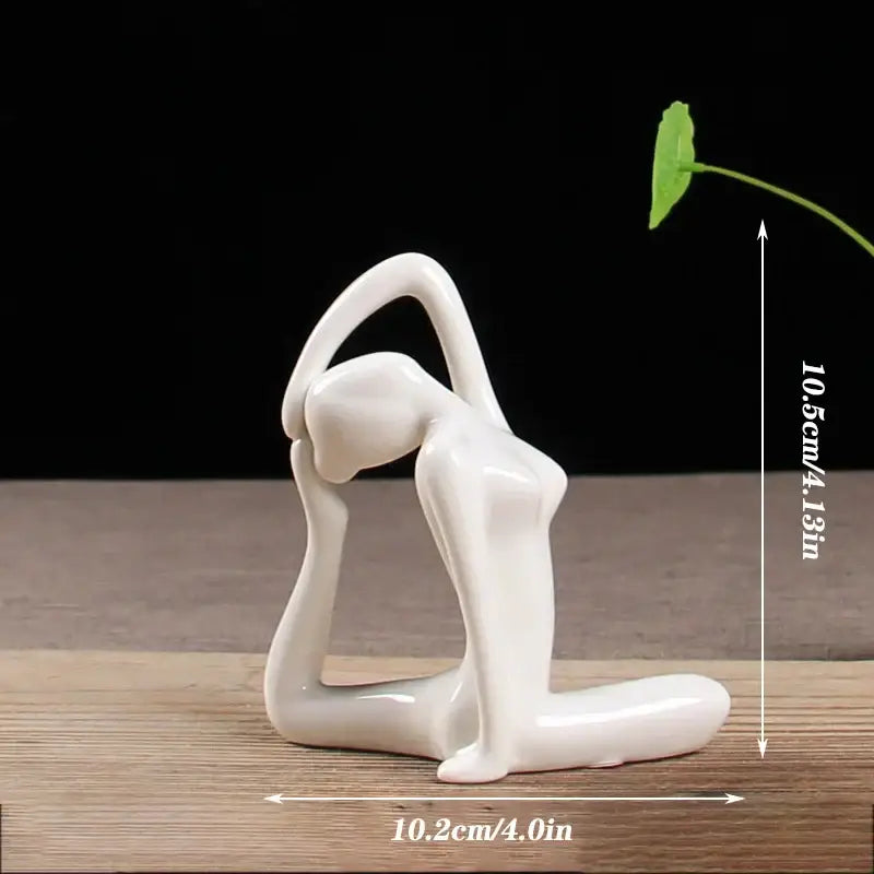A sleek glossy white porcelain yoga figure in an abstract pose for living room decorbites abstract yoga decor