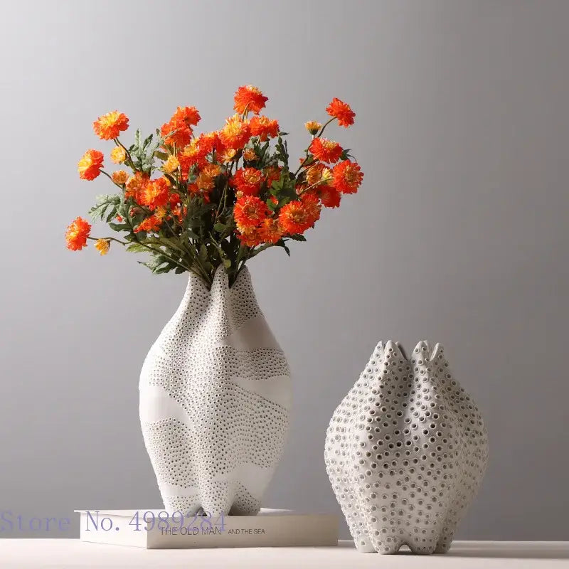 Abstract white textured ceramic vase with organic sculpted shape and dot pattern decorbites for living room decor