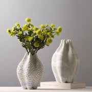 Abstract white ceramic vase with textured dot pattern and organic sculpted shape for living room decorbites decor