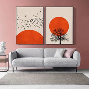 Gray textured fabric sofa with sleek black metal legs and two throw pillows beneath nordic style winter morning landscape canvas print