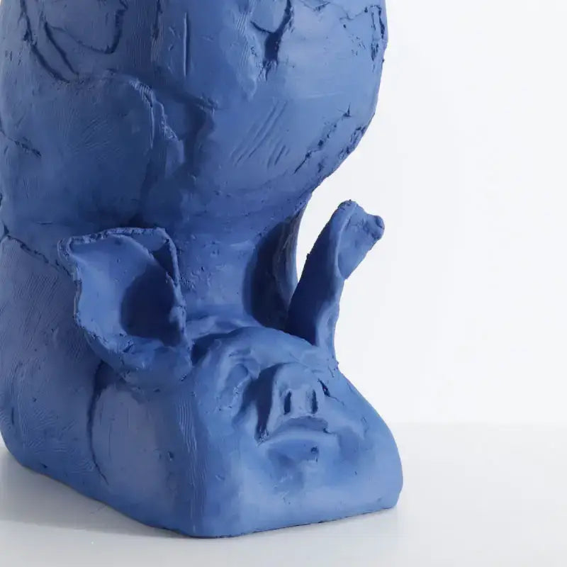 A blue ceramic cartoon pig sculpture with textured surfaces and prominent ears for decorbites cartoon pig handicrafts