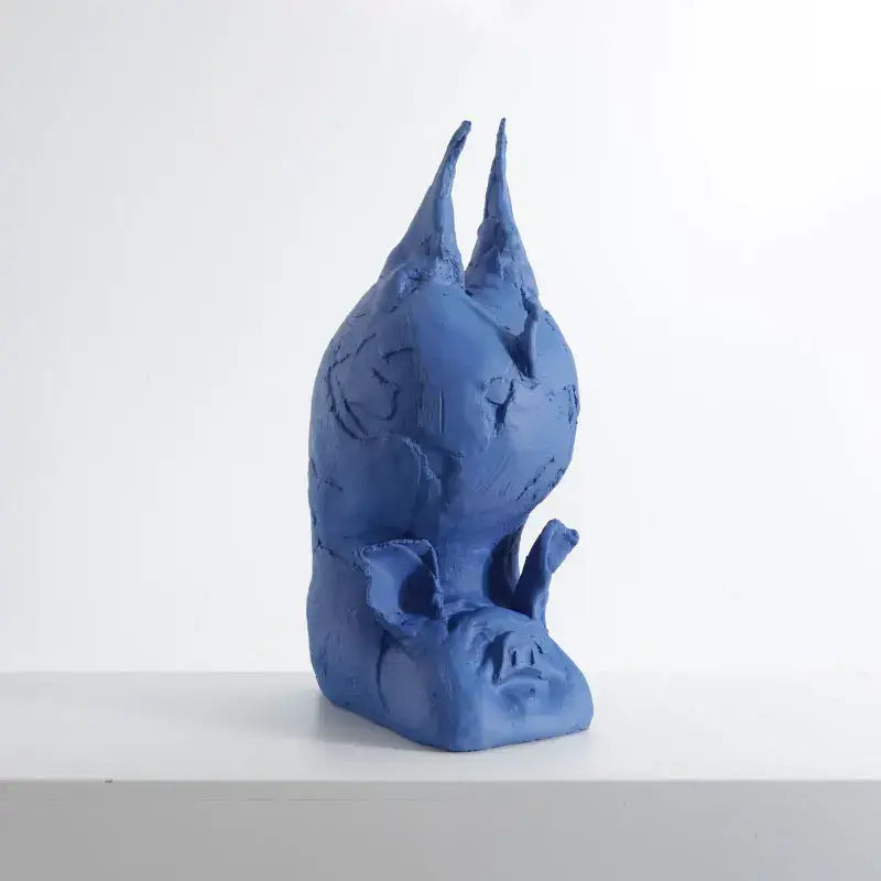A blue ceramic decorbites cartoon pig figurine with textured surfaces and inverted head for bedroom decor