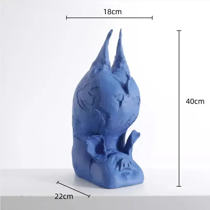 A blue ceramic decorbites cartoon pig sculpture with inverted head textured surfaces and pointed ears for bedroom decor