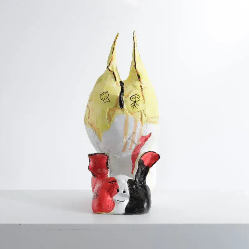A whimsical ceramic cartoon pig handicrafts figurine with yellow white upper body and red black rabbit decorbites decor